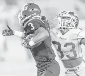  ?? Wilf Thorne ?? TSU’s Tylor Cook, left, offers Mark Pegues a good old-fashioned stiff-arm on his way to his second touchdown Saturday at BBVA Compass Stadium.