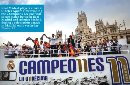  ??  ?? Real Madrid players arrive at Cibeles square after winning the Champions League final soccer match between Real Madrid and Atletico Madrid, during a celebratio­n parade in Madrid, early yesterday Photo: AP