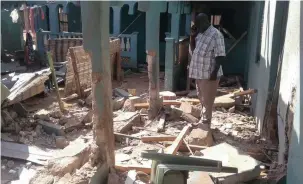  ?? PICTURE: EPA ?? IN RUINS: A man inspects the damage at a guest house attacked by suspected Islamist militants in the north-eastern town of Mandera, Kenya, killing 12 people, yesterday.