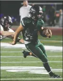  ?? DAVID WITTE/NEWS-SENTINEL ?? Liberty Ranch quarterbac­k Isiah Ricci (11) escapes the grasp of Laguna Creek's Joseph Ruiz (86) during a game at Hawk Stadium in September.