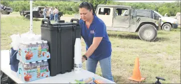  ??  ?? Isabel Hubbard, director of Fort Hood’s USO, sets up a field service station for emergency services workers assisting in search and recovery operations for four missing soldiers near the mobile command post at Fort Hood, Texas. — Reuters photo