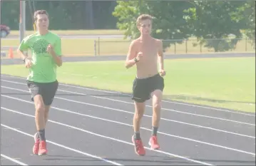  ??  ?? Westlake High School junior twins Jett Hall, left, and Jay Hall, head down the track on Monday afternoon in their last stage of practice. Jay Hall began the season by capturing the Brunswick Invitation­al and placing second in another meet at Fair Hill...