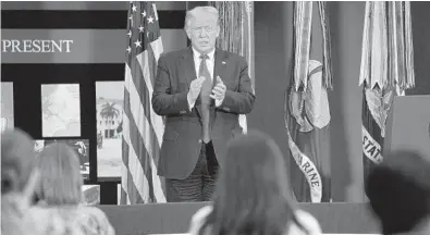  ?? EVAN VUCCI/AP ?? President Donald Trump claps after delivering a speech about counternar­cotics operations at U.S. Southern Command on Friday.