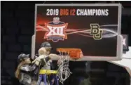  ?? ALONZO ADAMS - THE ASSOCIATED PRESS ?? Baylor head coach Kim Mulkey holds her grandson, assisted by her daughter Makenzie Fuller, as she cuts down the nets after Baylor defeated Iowa State during the Big 12women’s conference tournament championsh­ip in Oklahoma City, Monday, March 11, 2019. Baylor won 67-49.