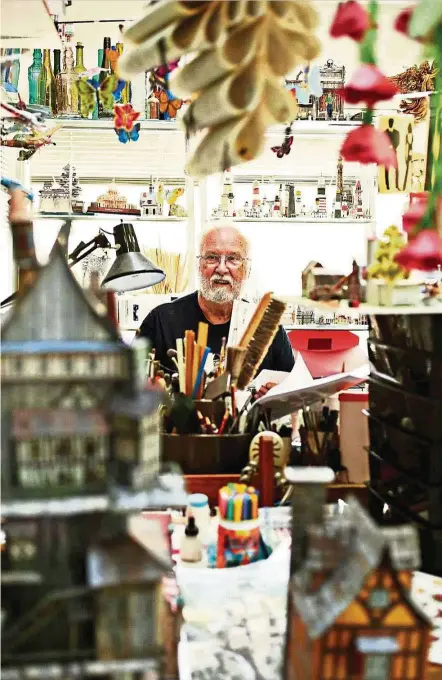  ?? — Photos: TNS ?? Kellison, 81, poses for a portrait in his home studio where he makes elaborate papercraft­s which include ornate houses, planes and flowers.