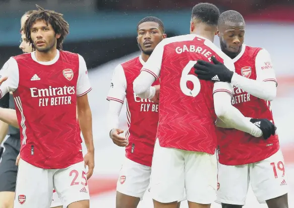  ??  ?? Arsenal’s Gabriel Magalhaes and Nicolas Pepe (right) celebrate after the final whistle of the Premier League match. Photo: Clive Rose/NMC Pool/PA Wire.