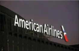  ?? MICHAEL AINSWORTH — THE ASSOCIATED PRESS ?? American Airlines reported Thursday that fourth-quarter profit slipped 11 percent as higher costs for fuel and labor offset rising revenue.