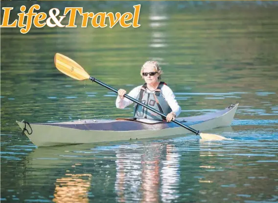  ?? JERRY JACKSON/BALTIMORE SUN ?? Kasia Taylor paddles off her community beach in Severna Park in a wooden kayak built for her by her husband Jay Taylor, who has assembled four crafts in his garage.