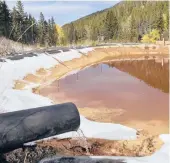  ?? MATTHEW BROWN/AP 2018 ?? Water contaminat­ed with arsenic, lead and zinc flows from a pipe out of the Lee Mountain mine and into a holding pond near Rimini, Montana.