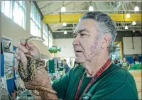  ?? Bobby Block/The Signal ?? Bill Weber and his snake staff the Placerita Nature Center booth at the Environmen­tal Expo, which accompanie­d the annual River Rally Clean-Up on Saturday.