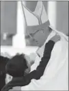  ?? L’OSSERVATOR­E ROMANO, THE ASSOCIATED PRESS ?? Pope Francis is hugged by Lucas Baptista. His mysterious healing was the “miracle” needed for sainthood.