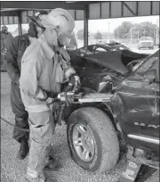  ?? Tammy Weinman ?? Pictured above is Arnold Fire Chief Eric Nelson using hydraulic tools during extricatio­n training in Arnold.