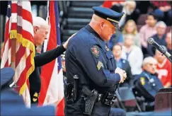  ??  ?? Westervill­e Police Sgt. Greg LeValley is consoled by the Rev. James Meacham, a department chaplain, before speaking at a gathering Sunday at Westervill­e North High School.