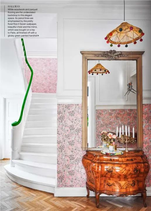  ??  ?? HALLWAY
White woodwork and parquet flooring are the understate­d backdrop to this elegant space. Its period lines are emphasised by the pretty floral Rice II Seven wallpaper, beautiful chest and the mirror, which was bought on a trip to Paris, all finished off with a glossy green painted handrail