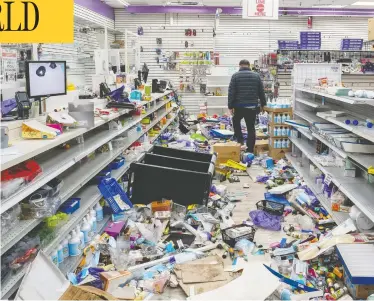  ?? DAVID `DEE' DELGADO / REUTERS ?? A business owner walks in his looted beauty supply store Tuesday following protests over the fatal police shooting of 27-year-old Black man Walter Wallace in Philadelph­ia. Wallace was dealing with mental health issues, his family says.