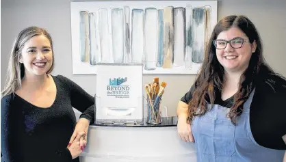  ?? ERNESTO CARRANZA/THE GUARDIAN ?? Stephanie Dawson and Katie Murray put the finishing touches on their new business, Beyond the Bridge Therapy Centre on Walker Avenue in Summerside. The new centre will provide therapy and art therapy services to Island residents.