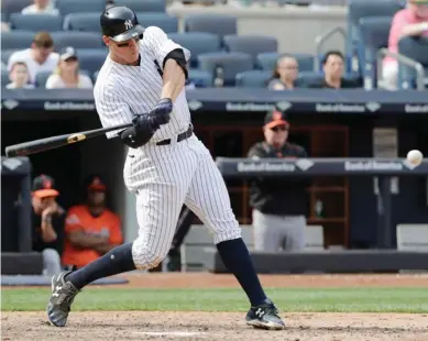  ?? (Photo by Frank Franklin II, AP) ?? New York Yankees' Aaron Judge hits a home run during the seventh inning of Saturday's game against the Baltimore Orioles.