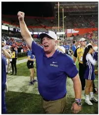  ?? AP/JOHN RAOUX ?? Kentucky head Coach Mark Stoops celebrates with fans after the Wildcats defeated Florida 27-16 for their first victory over the Gators since 1986.