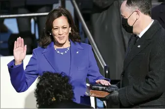  ?? SAUL LOEB — POOL PHOTO VIA AP ?? Kamala Harris is sworn in as vice president by Supreme Court Justice Sonia Sotomayor as her husband, Doug Emhoff, holds the Bible during the 59th Presidenti­al Inaugurati­on at the U.S. Capitol on Wednesday.