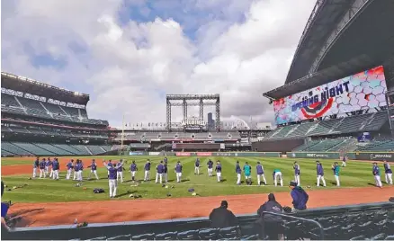  ?? THE ASSOCIATED PRESS ?? Seattle Mariners players stretch during Wednesday’s practice as they prepare for their season opener against Cleveland. Today is opening day across Major League Baseball.