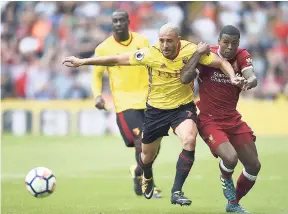  ?? AP ?? Watford’s Nordin Amrabat (left) and Liverpool’s Georginio Wijnaldum battle for the ball during the English Premier League match at Vicarage Road, Watford, England, yesterday.