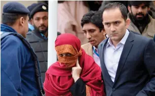  ?? AP file ?? The wife of the judge is escorted from the Supreme Court by her brother in Islamabad. —