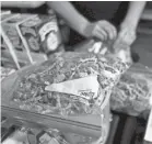  ?? RICHARD VOGEL/AP ?? A vendor bags psilocybin mushrooms at a pop-up cannabis market in Los Angeles last month.