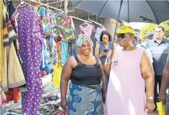  ?? | DOCTOR NGCOBO African News Agency (ANA) ?? ETHEKWINI mayor Zandile Gumede, right, interacted with beach vendors when she went on a walkabout along the beachfront yesterday. Rita Luphanga from Mariannhil­l shows the mayor what she has to offer tourists.
