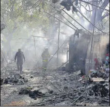  ?? ANSHUMAN POYREKAR/HT PHOTO ?? Fire brigade officials extinguish fire at Fashion Street near Churchgate where 12 shops were gutted on Saturday afternoon.