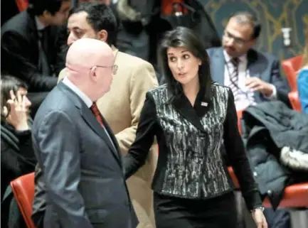  ??  ?? Russian Ambassador to the UN Vasilly Nebenzia talks with his US counterpar­t Nikki Haley before the start of a UN Security Council meeting in Iran. (AFP/file)