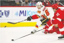  ?? GREGORY SHAMUS/GETTY IMAGES ?? Andrew Mangiapane of the Flames scores a third-period empty-net goal against the Detroit Red Wings Sunday in Detroit. Calgary won the Game 4-2.