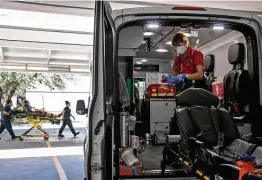  ??  ?? Paramedic Katheryn Wieding sterilizes the ambulance after transporti­ng a patient, a process that is even more detailed amid the pandemic.