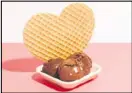  ?? CONTRIBUTE­D BY JENI’S SPLENDID ICE CREAMS ?? On Valentine’s Day, all Jeni’s Splendid Ice Creams shops will serve a “Study in Chocolate,” a trio of Roxbury Road, Darkest Chocolate and Milkiest Chocolate scoops crowned with a crisp, heart-shaped waffle.
