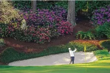  ?? DAVID J. PHILLIP/ASSOCIATED PRESS ?? Rory McIlroy hits from the bunker on the 13th hole during a practice round for the Masters golf tournament on Tuesday in Augusta, Ga. McIlroy has had mixed success at Augusta National.
