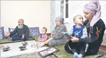 ?? ?? Sattoriy, his wife Nargiza Jabbarova, 28, and their children in their house in Termez.