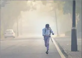  ??  ?? A boy on his way to school on smoggy morning at Teen Murti Marg. The air quality in Delhi slipped back to the ‘very poor’ category on Monday.