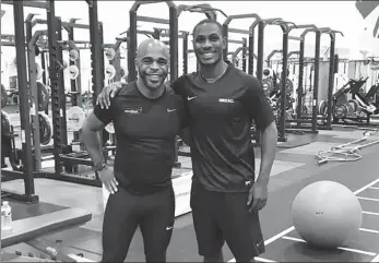  ?? AFP ?? Fitness coach and mentor Wayne Richardson (left) poses with one of his most high-profile clients, Manchester United’s on-loan Shanghai Shenhua striker Odion Ighalo, in a Manchester gym.