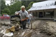  ?? TIMOTHY D. EASLEY — THE ASSOCIATED PRESS ?? Volunteers from the local mennonite community clean flood damaged property from a house July 30at Ogden Hollar in Hindman, Ky.