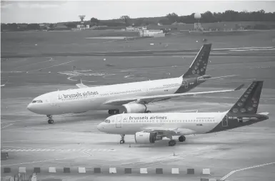  ?? FRANCISCO SECO/AP 2020 ?? The EU is being pressured to tweak rules on airport landing slots. Above, two Brussels Airlines jets in Belgium.