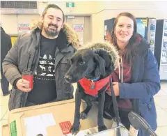  ?? ROSIE MULLALEY/ THE TELEGRAM ?? Tristan Cleveland Thompson and Shannah Rastin with their new addition to the family, Piper, after arriving at St. John’s Internatio­nal Airport from Halifax Wednesday morning. Rastin went to St. Stephen, N.B., to pick up the pooch, a rescue from Texas, but was delayed arriving home by a few days due to the airport closing after the massive snowstorm that hit the metro region last Friday.