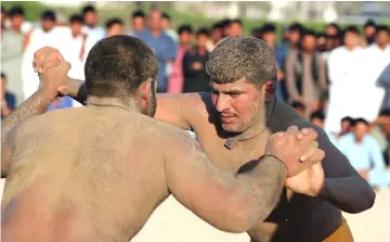  ??  ?? Every Friday evening in Dubai’s bustling Deira district, a sandy lot is transforme­d into the ring of champions. Fishmonger­s leave behind the stink of the market for the sweaty stink of another gripping match.