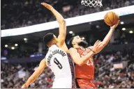  ?? Frank Gunn / Associated Press ?? Toronto Raptors guard Fred VanVleet ( 23) goes for a layup as Nets guard Timothe Luwawu- Cabarrot defends during the second half Saturday.