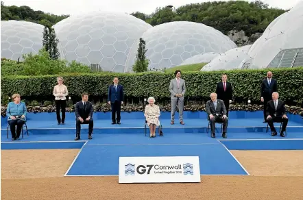  ?? AP ?? Britain’s Queen Elizabeth II poses for a group photograph with G7 leaders, from left, back row, President of the European Commission Ursula von der Leyen, Japan’s Prime Minister Yoshihide Suga, Canada’s Prime Minister Justin Trudeau, Italy’s Prime Minister Mario Draghi and President of the European Council Charles Michel. From left, front row, German Chancellor Angela Merkel, French President Emmanuel Macron, Britain’s Prime Minister Boris Johnson and US President Joe Biden before a reception at the Eden Project in Cornwall.