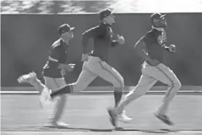  ?? ASSOCIATED PRESS ?? Brewers outfielders, from left, Corey Ray, Avisail Garcia and Lorenzo Cain run during a spring training workout last week.