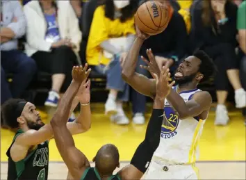  ?? John Hefti/Associated Press ?? Andrew Wiggins, right, had 26 points and 13 rebounds Monday night to help Golden State take a 3-2 series lead in the NBA Finals with a 104-94 win against Boston in San Francisco.