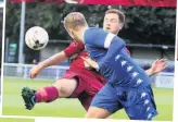  ??  ?? Bangor City’s Steve Hewitt puts his head into this challenge against Holyhead Hotspur