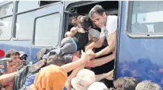  ??  ?? Desperate Syrian refugees causing total chaos, as they leave the Greek island of Lesbos