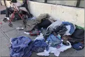  ?? JANIE HAR — THE ASSOCIATED PRESS FILE ?? Sleeping people, discarded clothes and used needles are seen on a street in the Tenderloin neighborho­od in San Francisco on July 25, 2019. The Democratic mayor of San Francisco is pushing a pair of controvers­ial public safety proposals on the March 5ballot.
