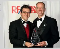  ?? ?? Aaron Drever, left, receiving a sales award while a RE/MAX real estate agent.
