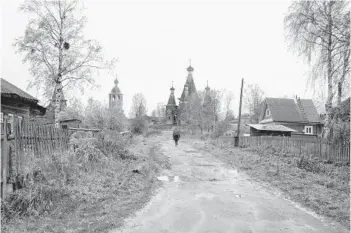  ?? SERGEI YAKOVLEV/AP ?? In this photo taken in October 2018, a person walks in the village of Nyonoksa, northweste­rn Russia. The Aug. 8, 2019, explosion of a rocket engine at the Russian navy’s testing range just outside Nyonoksa led to a brief spike in radiation levels and raised new questions about prospectiv­e Russian weapons.